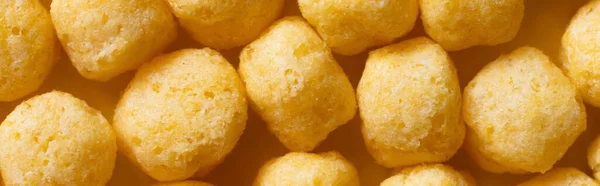 Top view of puffed, delicious and salty cheese pops, banner — Stock Photo