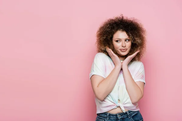 Pretty woman in t-shirt looking away isolated on pink — Stock Photo