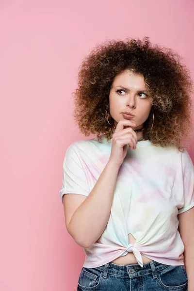 Nachdenkliche junge Frau schaut isoliert auf rosa — Stockfoto