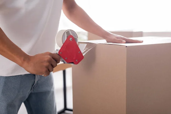 Cropped view of african american seller packaging carton box in online web store — Stock Photo