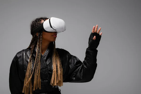 Afroamerikanerin in Handschuhen und Vr-Headset isoliert auf grau — Stockfoto