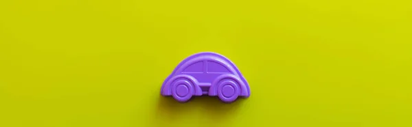 Top view of violet plastic car on bright yellow background, banner — Stock Photo