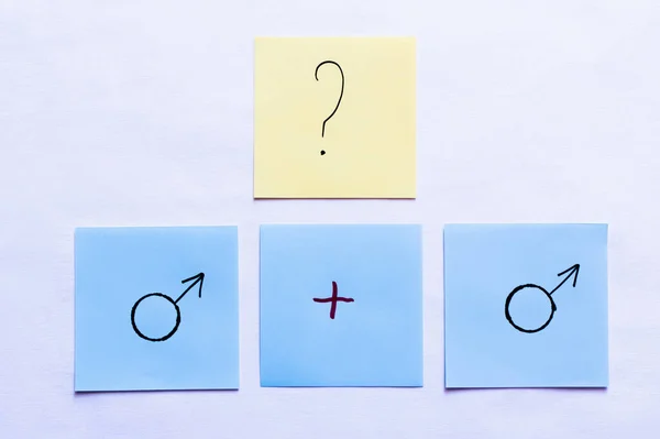Top view of cards with question mark and plus sign near male symbols on white background — Stock Photo