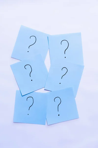 Top view of blue cards with question marks on white background — Stock Photo