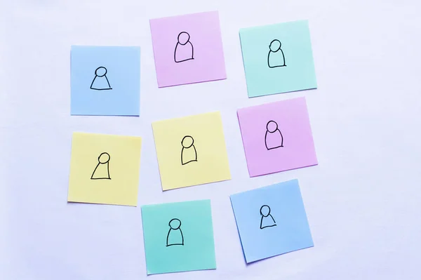 Top view of sticky notes with people icons on pastel purple background — Stock Photo