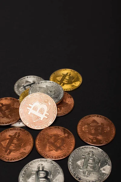 KYIV, UKRAINE - APRIL 26, 2022: Close up view of bitcoins on black background — Stock Photo