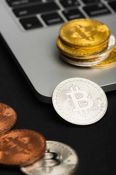 KYIV, UKRAINE - APRIL 26, 2022: Close up view of crypto coins on laptop on black background — Stock Photo