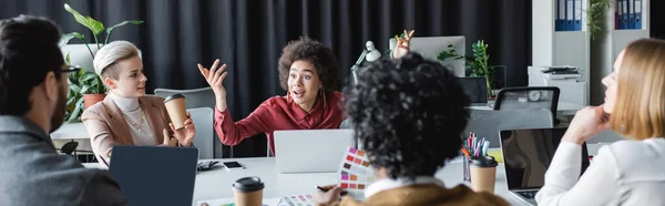 Excited african american woman talking to multicultural advertising managers during meeting, banner — Stock Photo
