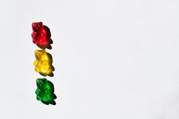 Top view of colorful gummy bears on white background with copy space — Stock Photo