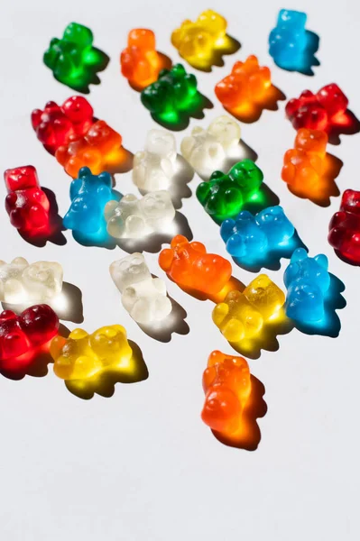 Top view of sweet and colorful gummy bears on white background — Stock Photo