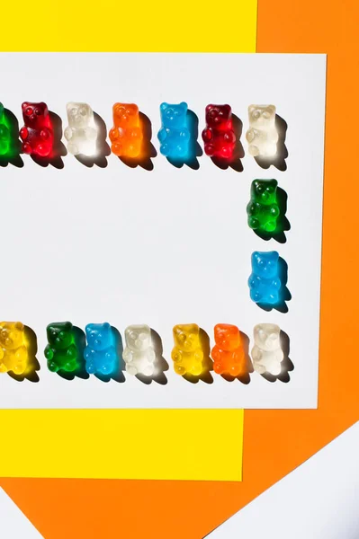 Flay lay of delicious gummy bears on colorful background — Stock Photo