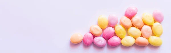 Top view of pink and yellow sweets on white background, banner — Stock Photo
