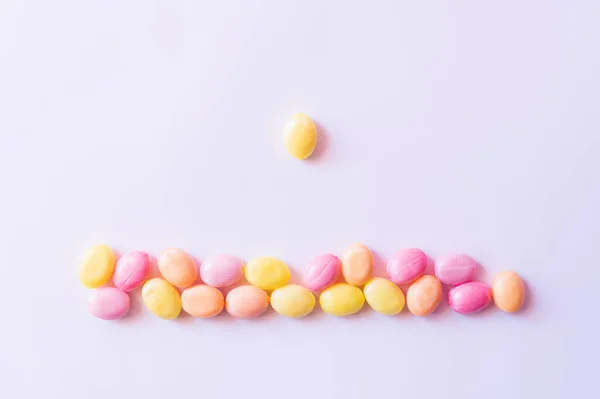 Top view of candy near colorful sweets on white background — Stock Photo