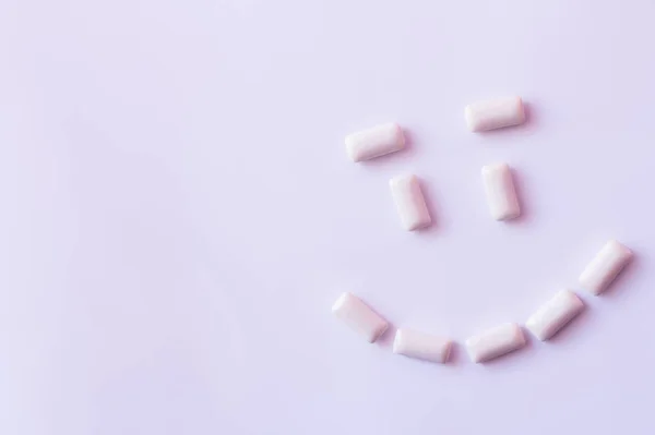 Flat lay with smile from chewing gums on white background — Stock Photo