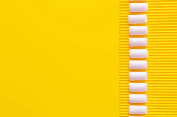 Flat lay with chewing gums on textured yellow background — Stock Photo