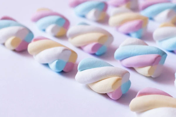 Close up view of colorful marshmallows on white surface — Stock Photo