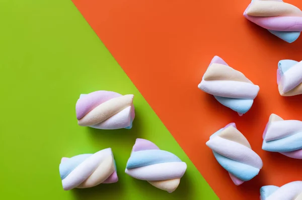 Vista superior de deliciosos marshmallows em fundo verde e laranja — Fotografia de Stock