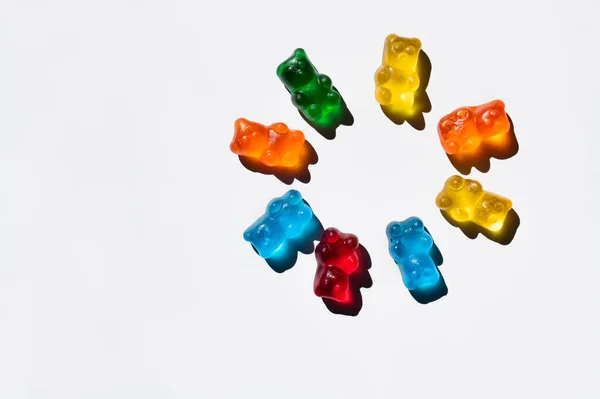 Flat lay with round from gummy bear on white background — Stock Photo