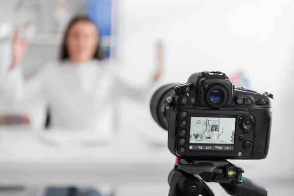 Digital camera near blurred doctor in white coat in hospital — Stock Photo