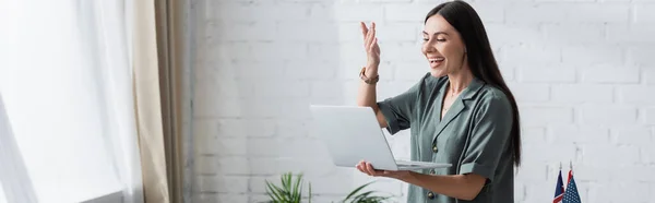 Positive teacher having video call on laptop in school, banner — Stock Photo