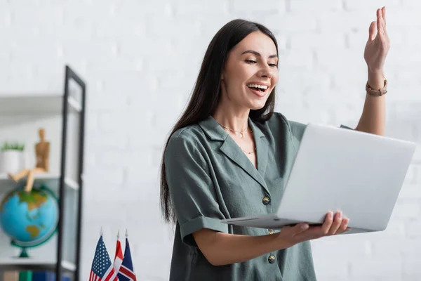 Teacher gesturing during online lecture on laptop in class — Stock Photo