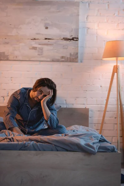 Young man suffering from sleep disorder on bed at home — Fotografia de Stock