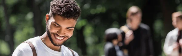 Fröhlicher afrikanisch-amerikanischer Student schaut draußen weg, Banner — Stockfoto