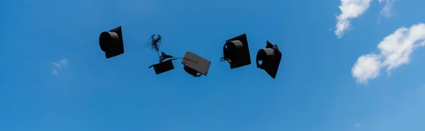 Low angle view of bachelor caps with sky at background, banner — Stock Photo