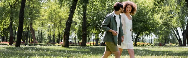 Heureux jeune couple ayant rendez-vous tout en marchant dans le parc vert, bannière — Photo de stock