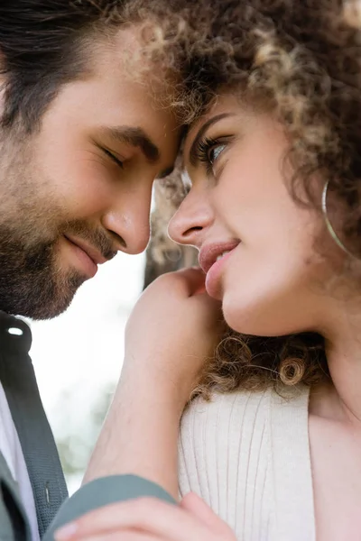 Portrait of young and curly woman looking at boyfriend — Stock Photo