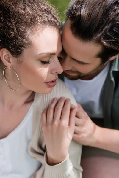 Portrait of bearded man and curly woman hugging with closed eyes — Stock Photo