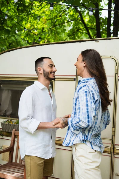 Glücklich tätowiert Homosexuell Mann hält Hände von fröhlichen Freund in der Nähe von Reisebus — Stockfoto