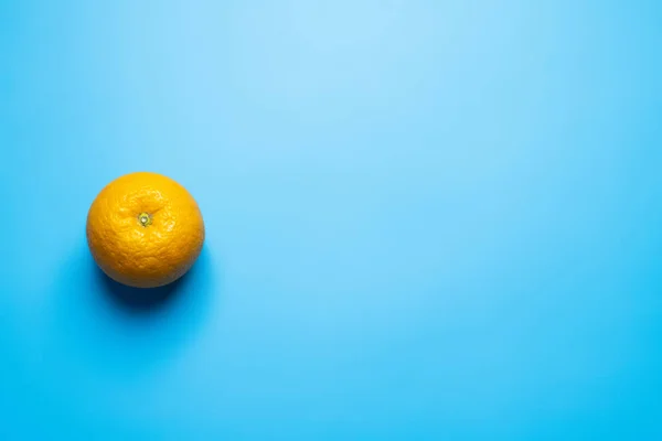Top view of orange on blue background — Stock Photo