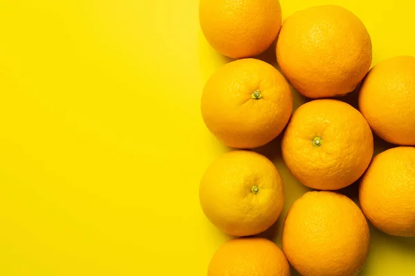 Top view of sweet oranges on yellow background with copy space — Stockfoto