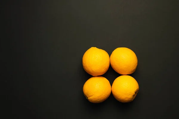 Top view of sweet oranges in peel isolated on black — Stock Photo