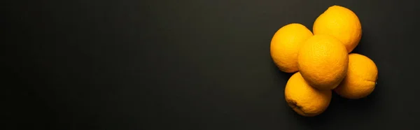 Top view of sweet tropical oranges isolated on black, banner — Stockfoto