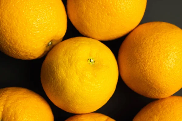 Close up view of bright oranges isolated on black — Stock Photo