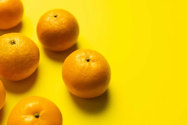 High angle view of sweet tangerines on yellow background — Stock Photo