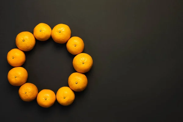 Top view of frame from mandarins on black background with copy space — Stock Photo