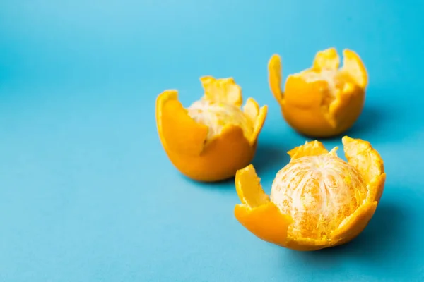 Close up view of fresh mandarins in peel on blue background with copy space — Stock Photo