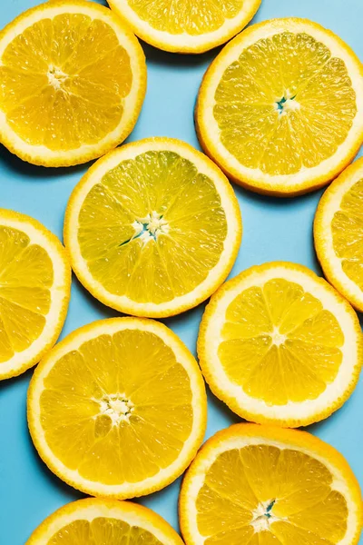 Top view of slices of tropical orange on blue surface — Stock Photo