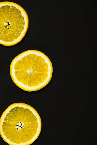 Верхній вигляд соковитих шматочків апельсинового кольору, ізольованих на чорному. — стокове фото