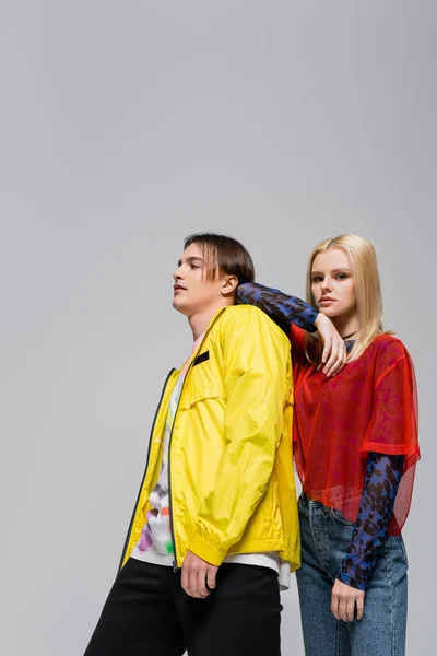 Blonde woman standing near stylish boyfriend isolated on grey — Stockfoto