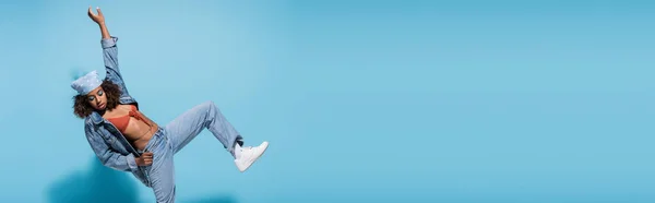 Trendy african american woman in denim clothes posing on blue background, banner — Stockfoto