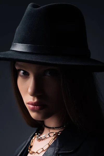 Portrait of teenage model in fedora hat looking at camera isolated on grey — Photo de stock