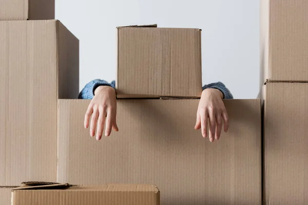 Woman in knitted cardigan near cardboard boxes isolated on white — Fotografia de Stock