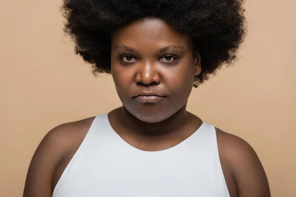 Portrait of offended african american plus size woman isolated on beige — Fotografia de Stock