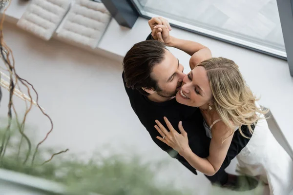 Overhead view of cheerful elegant couple dancing in restaurant — Stock Photo