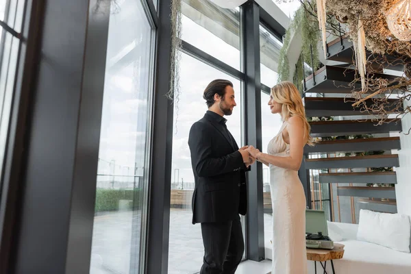 Side view of romantic couple holding hands in restaurant — Stock Photo