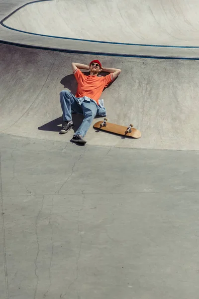 High angle view of skater lying on ramp in skate park — Stockfoto